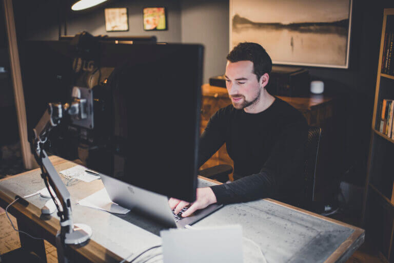 A photo of Nick Proctor, Amber's CEO, at a desk.