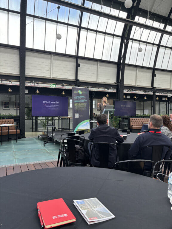 A photo of an Amber colleague at an event.